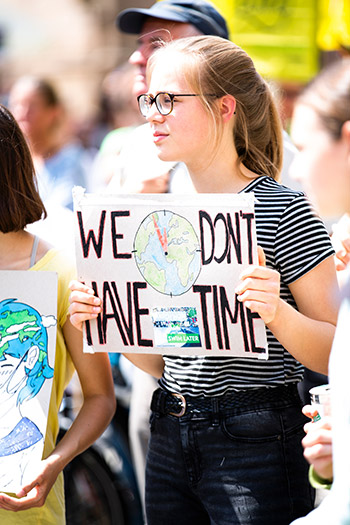 "We don't have time" student with protest sign